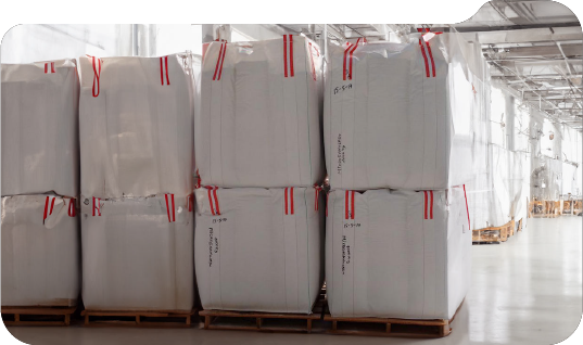 Filled NEGASAC Big Bags stacked in a warehouse