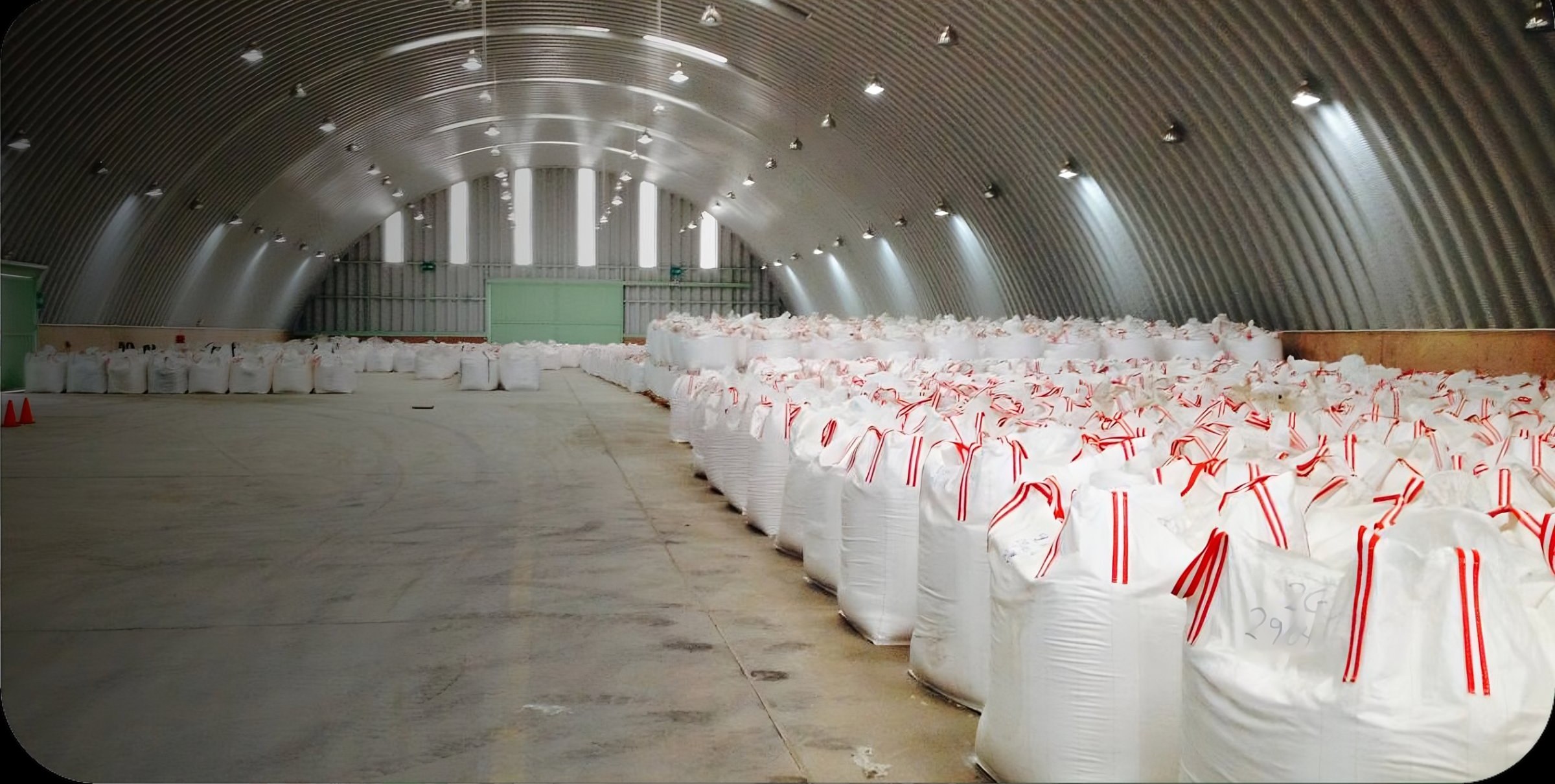 NEGASAC warehouse with hundreds of filled Big Bags with red and white loops